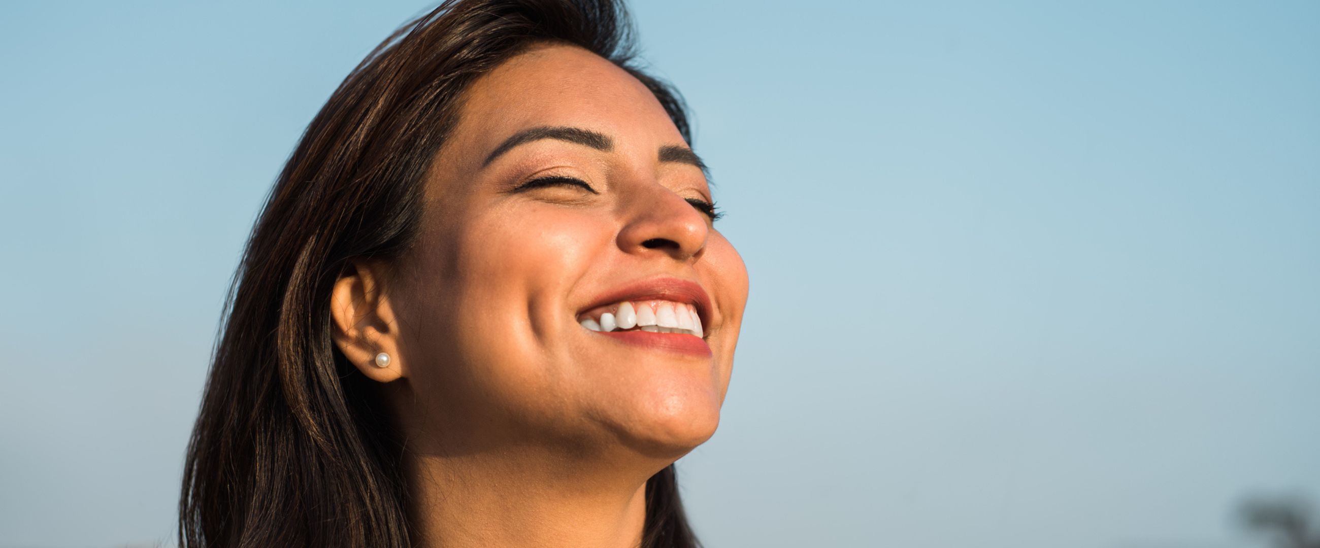 happy woman smiling in the sun