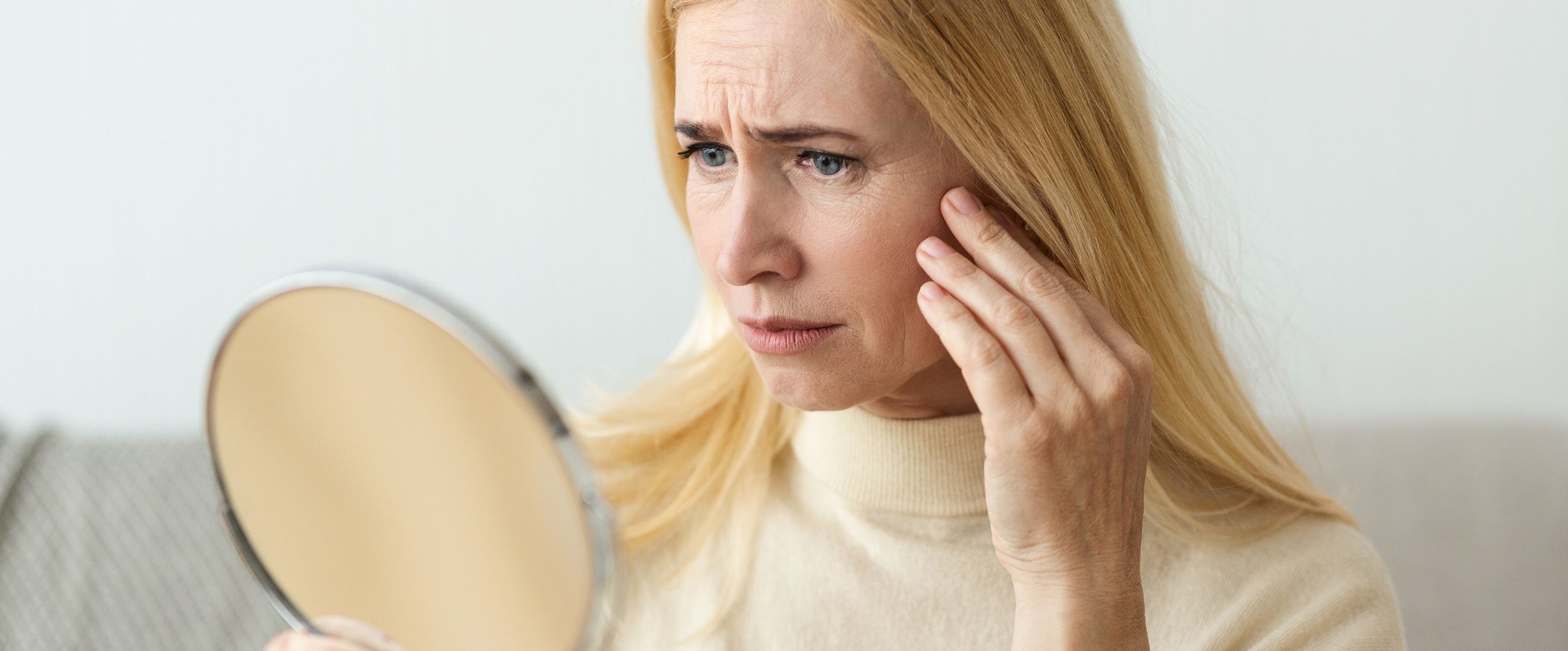 older woman concerned with sagging skin
